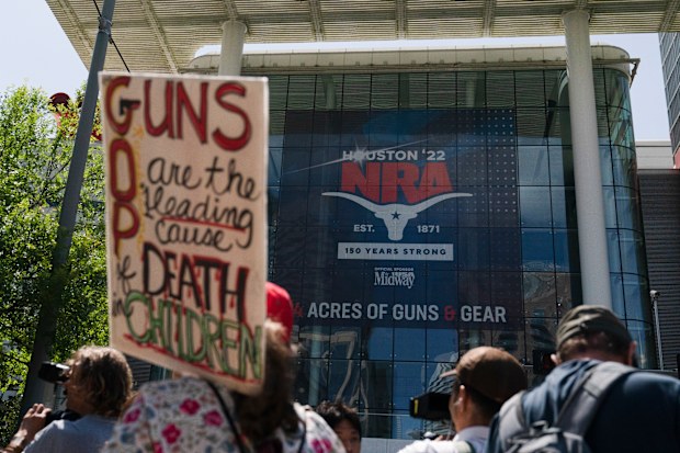 People gather outside the George R. Brown Convention Center to protest the National Rifle Association's annual meeting in Houston, Friday, May 27, 2022. (AP Photo/Jae C. Hong)
