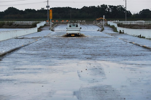 A truck drives through a flooded street Monday, Oct. 14, 2019, in Kawagoe City, Japan. Hagibis dropped record amounts of rain for a period in some spots, according to meteorological officials, causing more than 20 rivers to overflow. Some of the muddy waters in streets, fields and residential areas have subsided. But many places remained flooded, with homes and surrounding roads covered in mud and littered with broken wooden pieces and debris. (AP Photo/Eugene Hoshiko)