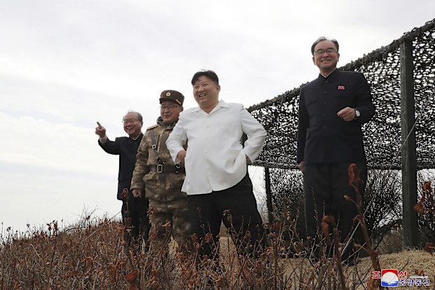 In this photo provided by the North Korean government, North Korean leader Kim Jong Un, second right, supervises what it says a test launch of a Hwasal strategic cruise missile during an exercise in North Korea Wednesday, March 22, 2023.  