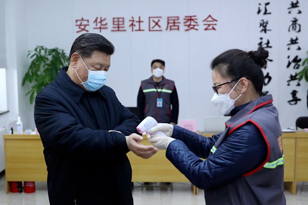 Chinese President Xi Jinping, left, wearing a protective face mask receives a temperature check.