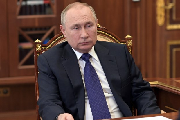 Russian President Vladimir Putin listens to St. Petersburg's governor Alexander Beglov during their meeting in the Kremlin in Moscow, Russia, Tuesday, March 1, 2022.