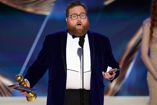 Paul Walter Hauser accepts the Best Performance in a Limited or Anthology Series or Television Film award for "Black Bird" onstage at the 80th Annual Golden Globe Awards 