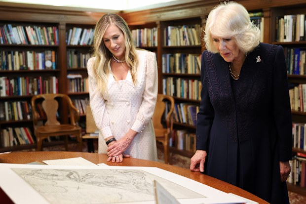 NEW YORK, NEW YORK - APRIL 29: (L-R) Sarah Jessica Parker and Queen Camilla examine artifacts on display during a literary engagement at New York Public Library on day three of the State Visit of King Charles III and Queen Camilla to the United States of America, on April 29, 2026 in New York, New York. Queen Camilla launched The Queens Reading Room in 2023, a charity working to celebrate and promote the power of reading across the UK and beyond. (Photo by Chris Jackson/Getty Images)