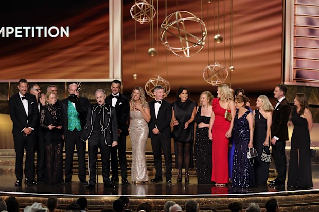 LOS ANGELES, CALIFORNIA - SEPTEMBER 14: Alan Cumming (6th L, holding trophy) and cast and crew of  "The Traitors" accept the Outstanding Reality Competition Program award onstage during the 77th Primetime Emmy Awards at Peacock Theater on September 14, 2025 in Los Angeles, California.  (Photo by Kevin Winter/Getty Images)