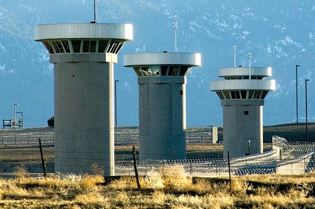 Guard towers loom over the prison.