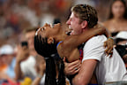 PARIS, FRANCE - AUGUST 08: Tara Davis-Woodhall of Team United States celebrates with her husband Hunter Woodhall after winning the gold medal in the Women's Long Jump Final on day thirteen of the Olympic Games Paris 2024 at Stade de France on August 08, 2024 in Paris, France. (Photo by Patrick Smith/Getty Images)