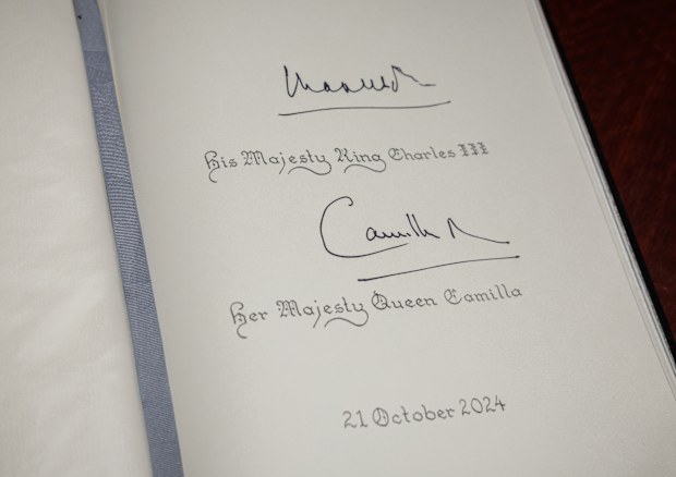 A visitor's book bearing the signatures of King Charles III and Queen Camilla is seen after they signed it at the Australian War Memorial on October 21, 2024 in Canberra, Australia. The King's visit to Australia will be his first as Monarch, and CHOGM in Samoa will be his first as Head of the Commonwealth. 