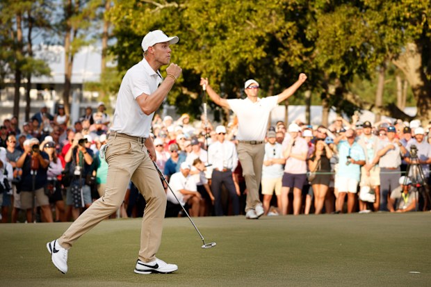 Cam Davis (L) of Australia and the International Team celebrates his hole-winning putt on the 17th green to win 1 Up with teammate Adam Scott (R)of Australia against Billy Horschel and Sam Burns of the United States Team during Saturday afternoon four-ball matches on day three of the 2022 Presidents Cup at Quail Hollow Country Club on September 24, 2022 in Charlotte, North Carolina. (Photo by Jared C. Tilton/Getty Images)