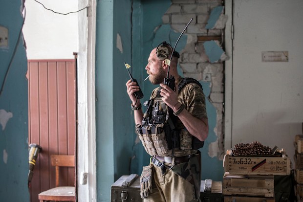 A Ukrainian soldier holds radios during heavy fighting on the front line in Severodonetsk, the Luhansk region, Ukraine, Wednesday, June 8, 2022