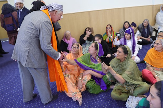 King Charles III speaks to congregation members during a visit to the newly built Guru Nanak Gurdwara on December 06, 2022 in Luton, England.  