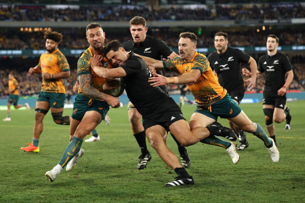 Anton Lienert-Brown of the All Blacks is tackled by Quade Cooper of the Wallabies during the Rugby Championship and Bledisloe Cup.