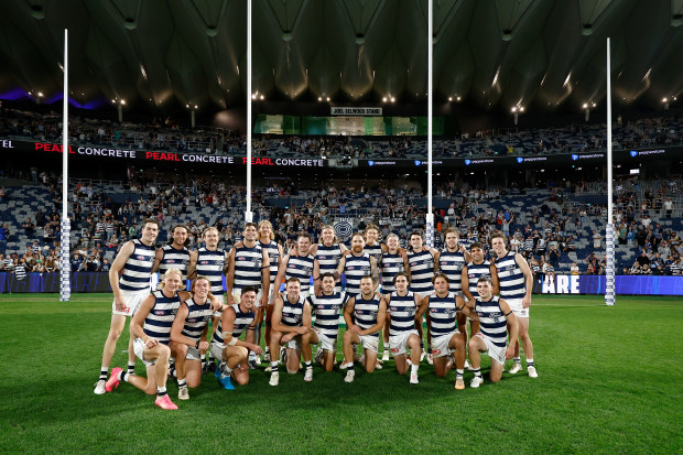 Geelong players pose in front of the new Joel Selwood Stand.