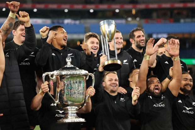 Injured All Blacks captain Sam Cane celebrates with teammates.