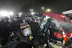 Police break through a barrier set up by pro-Palestinian demonstrators on the UCLA campus Thursday, May 2, 2024, in Los Angeles. (AP Photo/Jae C. Hong)
