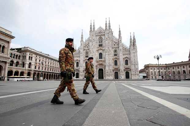 Italian soldiers patrol the square facing Duomo gothic cathedral in downtown Milan, Italy.