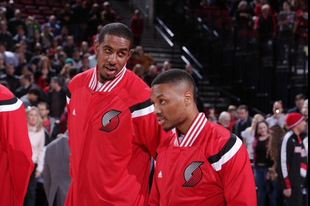PORTLAND, OR - DECEMBER 4: LaMarcus Aldridge #12 and Damian Lillard #0 of the Portland Trail Blazers stand for the national anthem before a game against the Indiana Pacers on December 4, 2014 at the Moda Center Arena in Portland, Oregon. NOTE TO USER: User expressly acknowledges and agrees that, by downloading and or using this photograph, user is consenting to the terms and conditions of the Getty Images License Agreement. Mandatory Copyright Notice: Copyright 2014 NBAE (Photo by Sam Forencich/