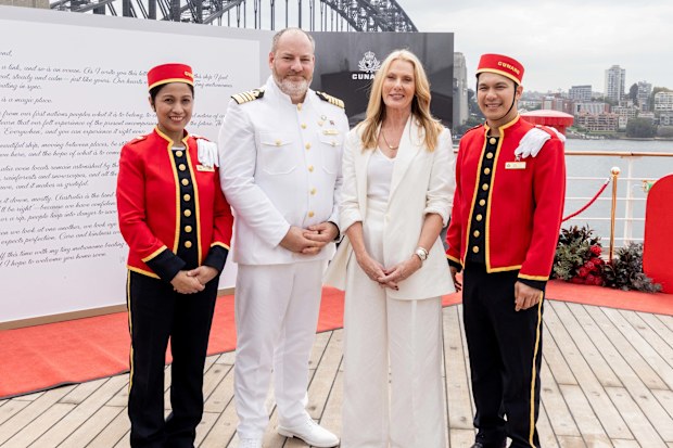 Anna Funder with Queen Mary 2 Captain Tomas Connery surrounded by the Cunard Bellhops copy