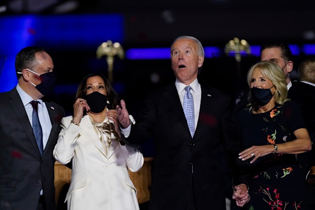 From left, Doug Emhoff, husband of Vice President-elect Kamala Harris, Harris, President-elect Joe Biden and his wife Jill Biden react after confetti was released Saturday, Nov. 7, 2020, in Wilmington, Del. (AP Photo/Andrew Harnik)