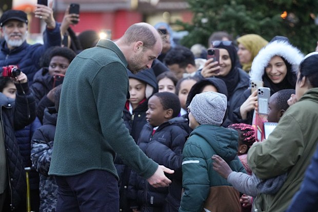 LIVERPOOL, ENGLAND - JANUARY 23: Prince William, Prince of Wales speaks to young well-wishers during a visit to the Tiber Young Peoples Steering Group to learn how they came together to lead the construction of a lively hub for the community in Toxteth on January 23, 2025 in Liverpool, England. The Prince of Wales visited key local community organisations in Toxteth that are making a significant impact in supporting and empowering young people in the area.  (Photo by Dominic Lipinski/Getty Image