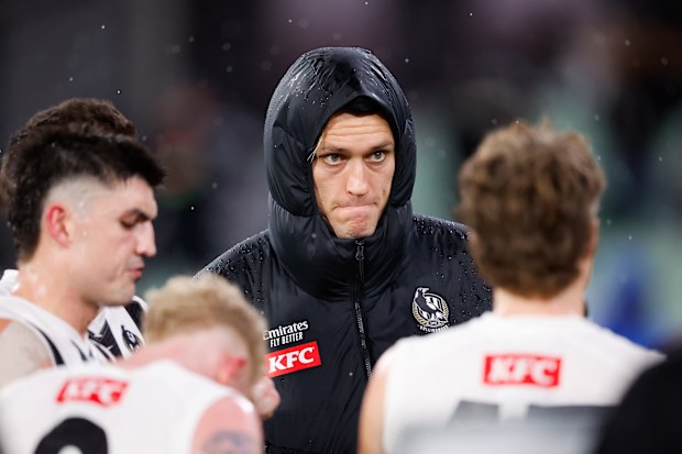 Darcy Moore of the Magpies is seen after being subbed out of the match against the Demons.