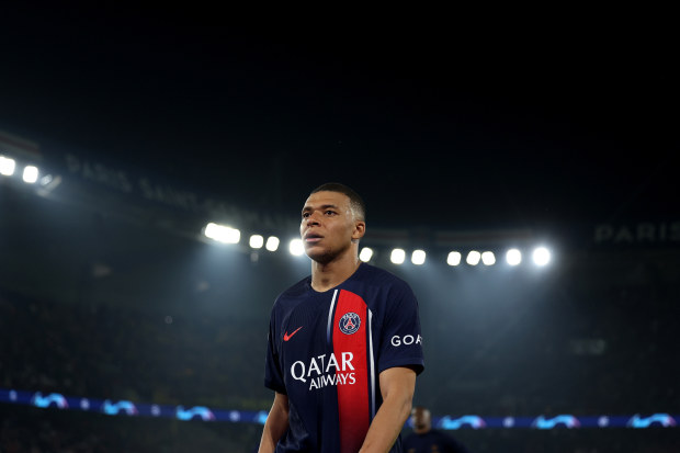 Kylian Mbappe of Paris Saint-Germain looks dejected as he leaves the field after defeat to Borussia Dortmund during the UEFA Champions League semi-final second leg match.