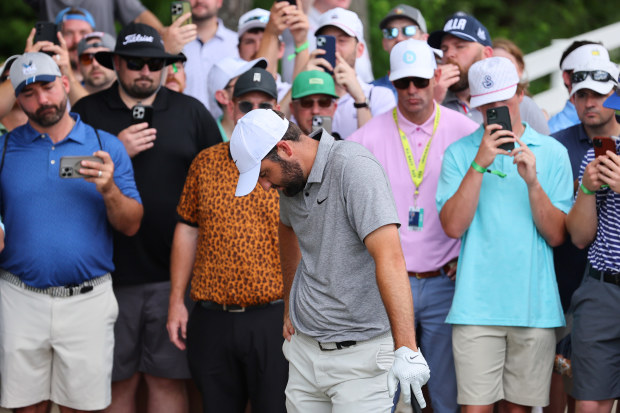 Spectators look on as Scottie Scheffler of the United States prepares to take a drop on the fourth hole during the third round of the 2024 PGA Championship at Valhalla Golf Club on May 18, 2024 in Louisville, Kentucky. (Photo by Michael Reaves/Getty Images)