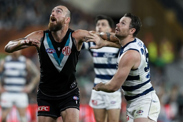 Charlie Dixon of the Power rucks against Patrick Dangerfield of the Cats in the qualifying final.