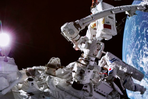 Chinese astronauts Cai Xuzhe, top and Chen Dong conducting extravehicular activities.