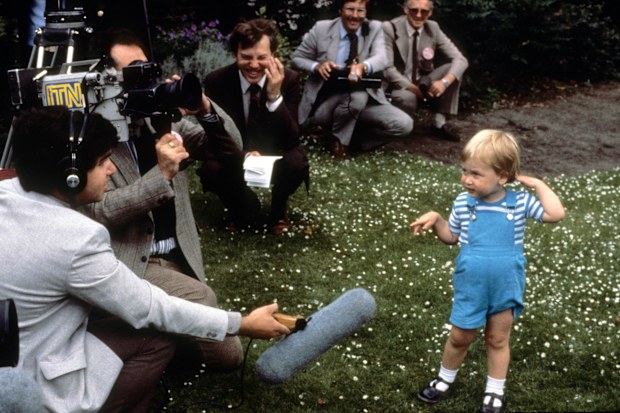 A young Prince William charms the press during a photocall for his second birthday in the gardens of Kensington Palace on June 12, 1984