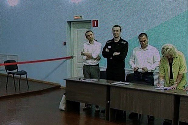 Russian opposition politician Alexei Navalny and his lawyers Olga Mikhailova, Vadim Kobzev and Alexander Fedulov appear on a screen via video link during an external hearing of the Moscow City Court in the criminal case against Navalny on numerous charges, including the creation of an extremist organization, at the IK-6 penal colony in Melekhovo in the Vladimir region, Russia, August 4, 2023. 