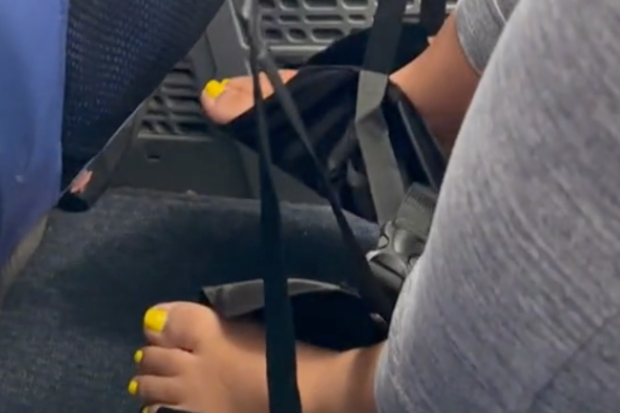 Woman in the US causes a stir with her bare foot sling on a plane.