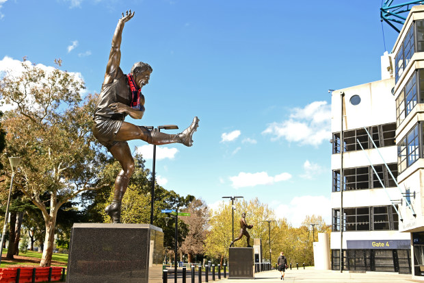 MELBOURNE, AUSTRALIA - SEPTEMBER 14: A Melbourne Demon's scarf hangs off the statue of Ron Barassi outside the MCG on September 14, 2021 in Melbourne, Australia. The Melbourne Demons play the Western Bulldogs in the 2021 AFL Grand Final at Optus Stadium in Perth on Saturday 25th September. The second Grand Final in history, and second consecutively to be played outside of Melbourne. (Photo by Quinn Rooney/Getty Images)