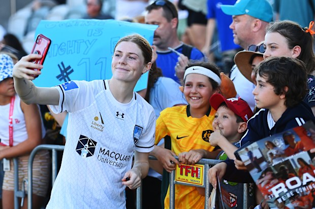Cortnee Vine of Sydney FC takes selfies with fans during the A-League Women round two match between Brisbane Roar and Sydney FC at Ballymore Stadium, on October 21, 2023, in Brisbane, Australia. 