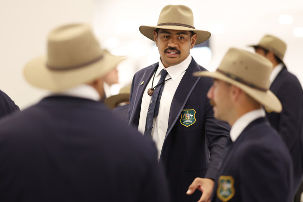 New Wallabies captain Will Skelton talks to teammates at Sydney International Airport.