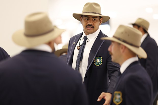 New Wallabies captain Will Skelton talks to team mates at Sydney International Airport.