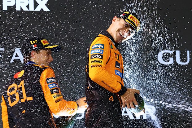 BAHRAIN, BAHRAIN - APRIL 13: Race winner Oscar Piastri of Australia and McLaren and Third placed Lando Norris of Great Britain and McLaren celebrate on the podium during the F1 Grand Prix of Bahrain at Bahrain International Circuit on April 13, 2025 in Bahrain, Bahrain. (Photo by Clive Rose/Getty Images) *** BESTPIX ***