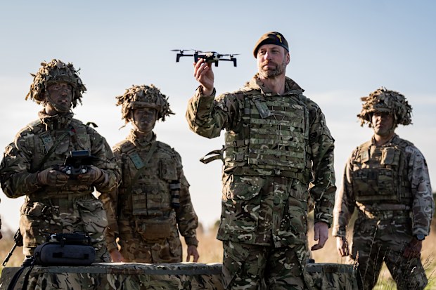 WILTSHIRE, ENGLAND - NOVEMBER 26: Prince William, Prince of Wales, Colonel of the Welsh Guards (2nd R) launching a drone during a visit to the 1st Battalion Welsh Guards to hear how they have been transitioning from ceremonial duty back to the Field Army at Salisbury Plain on November 26, 2024 in Wiltshire, England. (Photo by Aaron Chown - WPA Pool/Getty Images)