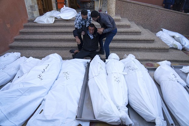 Palestinians mourn their relatives killed in the Israeli bombardment of the Gaza Strip