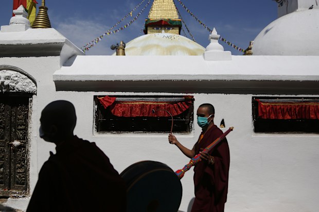 Buddhist monks participate in a parade to mark Buddha Jayanti festival, during lockdown at Boudhanath Stupa in Kathmandu, Nepal