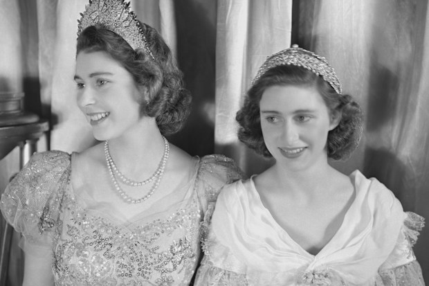 Princess Elizabeth (Queen Elizabeth II) and Princess Margaret (1930-2002), both dressed in elaborate gowns, pictured during a royal pantomime production of 'Old Mother Red Riding Boots' at Windsor Castle, Berkshire, Great Britain, 22 December 1944. (Photo by Lisa Sheridan/Studio Lisa/Getty Images)