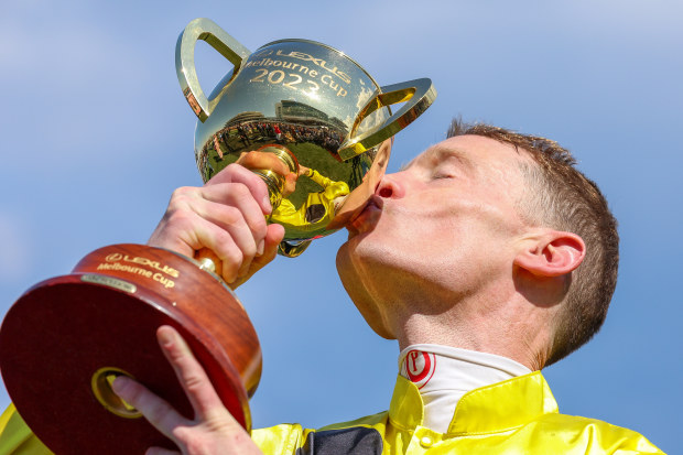 MELBOURNE, AUSTRALIA - NOVEMBER 07: Jockey Mark Zahra riding Without A Fight celebrates with the trophy after winning the Lexus Melbourne Cup during Melbourne Cup Day  at Flemington Racecourse on November 07, 2023 in Melbourne, Australia. (Photo by Asanka Ratnayake/Getty Images)