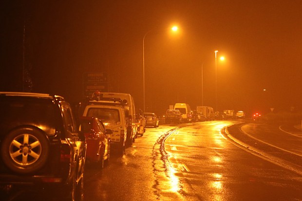 Cars line up on the roadside near Taree service centre, waiting for The highway to reopen after being inundated by flood waters