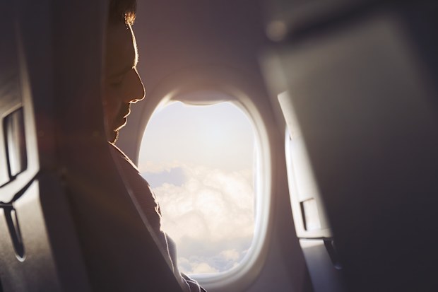 Businessman napping in airplane on his business travel
