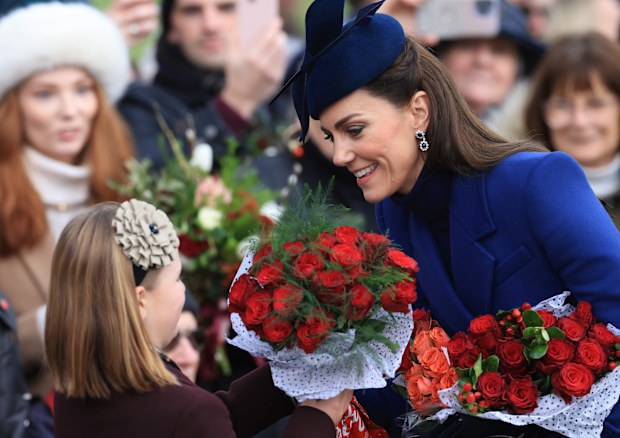 Mia Tindall receives flowers from well-wishers alongside Catherine, Princess of Wales  while attending Christmas Morning Service at Sandringham Church on December 25, 2023.