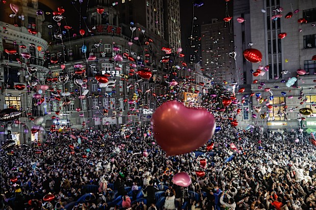 Revellers release balloons to celebrate the New Year on pedestrian street Jianghan Road on December 31, 2022 in Wuhan, China.