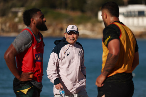 Wallabies coach Eddie Jones talks to players at Coogee Beach.