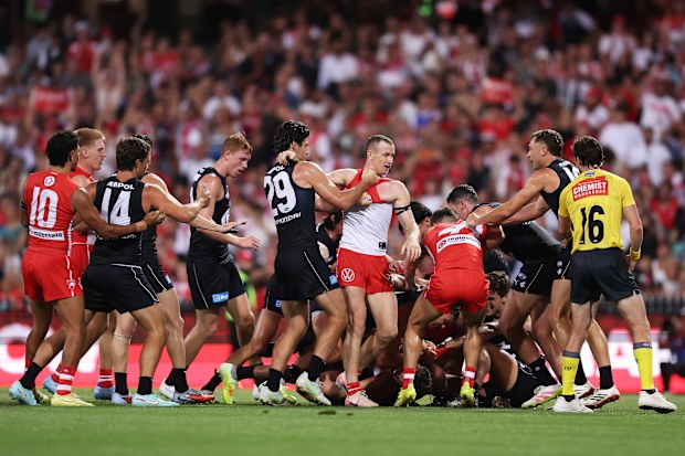 Players wrestle during the opening round AFL match between Sydney Swans and Carlton Blues.