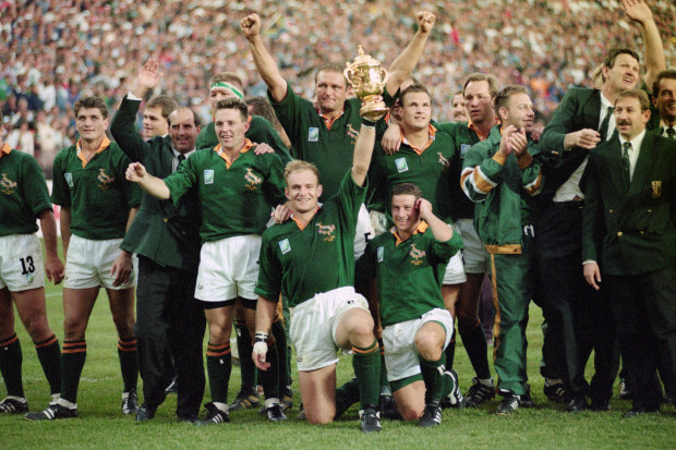 South Africa captain Francois Pienaar holds aloft the Webb Ellis trophy as the rest of the team celebrate after their 1995 World Cup Final victory over New Zealand at Ellis Park.