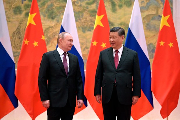 Chinese President Xi Jinping, right, and Russian President Vladimir Putin pose for a photo prior to their talks in Beijing, China, Friday, Feb. 4, 2022. Russian President Vladimir Putin is in Beijing for the Winter Olympics and talks with his Chinese counterpart Xi Jinping, amid soaring tensions with Ukraine.