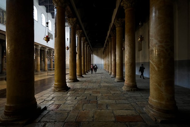 People visit the Church of the Nativity,  traditionally believed to be the birthplace of Jesus Christ, on Christmas Eve in the West Bank city of Bethlehem, Friday, Dec. 24, 2021. 